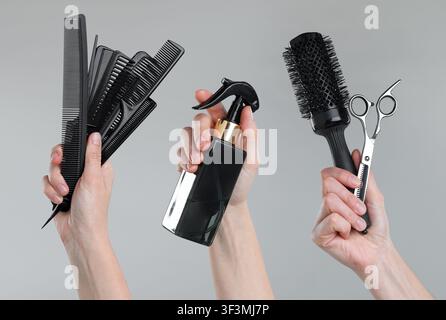 Hairdressers holding different tools in hands on grey background, set Stock Photo