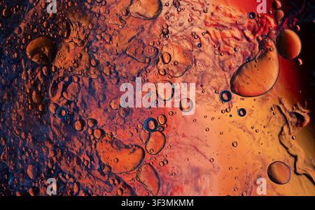 Macro view of oil drops and water mixing, forming an abstract background Stock Photo