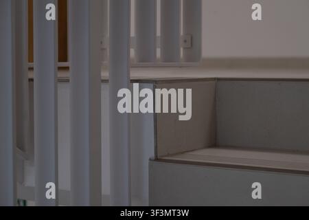 Minimalist staircase with safety handrails in a contemporary residential building. Clean architectural detail featuring modern construction, accessibi Stock Photo