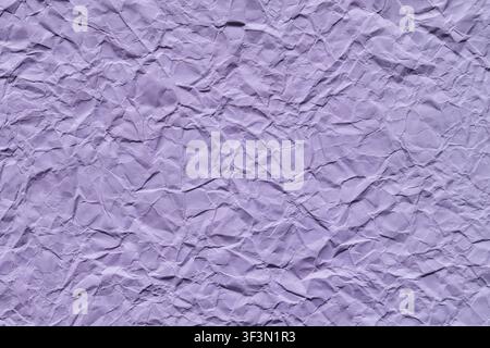 Crumpled lavender purple paper texture background with wrinkles and creases Stock Photo
