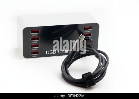 Modern usb charger hub with multiple ports and a type c cable on white background Stock Photo