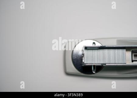 Open red stapler and staple strip isolated on white background, office supply concept. Stock Photo