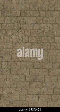 A top-down view of a worn, weathered cobblestone street surface. Stock Photo