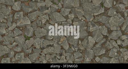 A detailed texture shot of the ground covered with loose gray granite rocks, gravel, pebbles, and small autumn leaves. Stock Photo