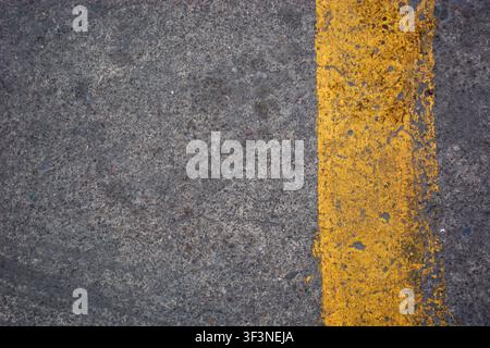 Yellow road marking paint on the concrete floor Stock Photo