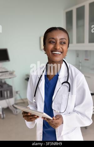 Happy young African American doctor woman using digital tablet Stock Photo