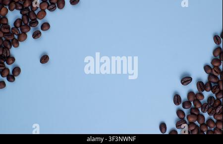 Roasted Coffee Beans Border on Blue Background with Empty Space Stock Photo