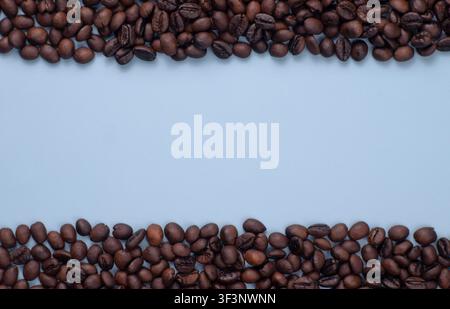 Roasted Coffee Beans Frame on Blue Background with Copy Space Stock Photo