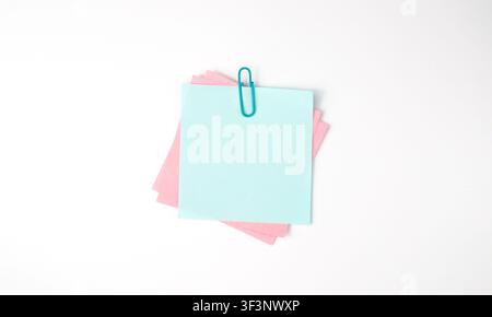 Pastel Sticky Notes with Blue Clip on White Background Stock Photo