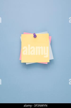 Pastel Sticky Notes Pinned on Blue Background Stock Photo