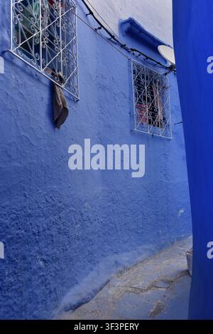 Traditional painted houses along a narrow blue street in Chefchaouen Medina, Morocco Stock Photo