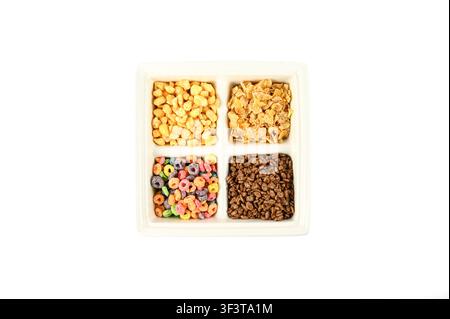 Various assorted breakfast cereals in a four-section serving dish on white background Stock Photo