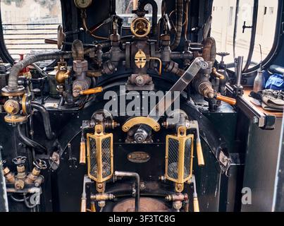 Historic steam locomotive interior, vintage railway engineering and industrial heritage, detailed controls and gauges in the driver s cab, Bruchhausen Stock Photo