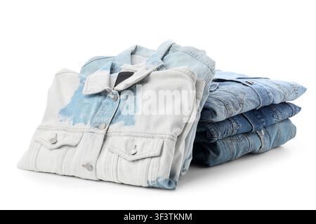 Stack of folded denim jackets and jeans, casual fashion and clothing retail concept, isolated on a white background Stock Photo