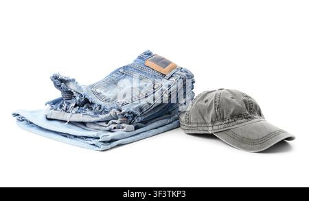 Stack of folded blue denim jeans and a gray baseball cap, casual fashion and everyday apparel Stock Photo