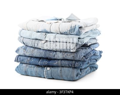 Stack of folded blue denim jeans and shirts in various washes, casual fashion and apparel concept, isolated on a white background Stock Photo