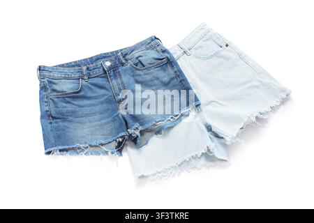 Two pairs of denim shorts in different washes light blue and classic blue with frayed hems isolated on a white background Stock Photo