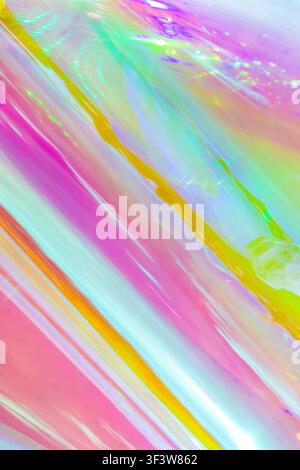 A vibrant abstract image featuring holographic effects with a bright, shiny surface. Rainbow colors blend seamlessly, creating a dynamic and eye-catch Stock Photo