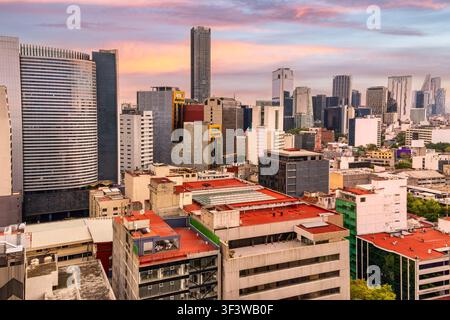 Aerial view of Mexico City skyline rising above the lush green canopy ...