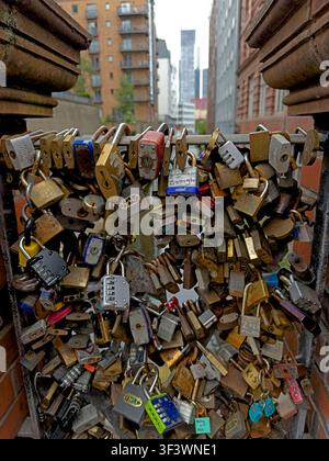 Lovelocks attached to a city-centre canal bridge Oxford Road  in Manchester, England, UK. Stock Photo