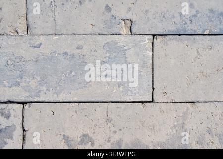 Light Gray Limestone Block Pavement Texture Background with Natural Stone Pattern. Stock Photo