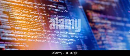 DevOps server monitoring and predictive performance analytics concept. Python code on dark screen with orange and blue light leaks. Panoramic backgrou Stock Photo