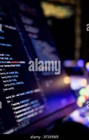 System monitoring and critical error log on computer screen. Vertical coding background with depth of field and neon lights. Stock Photo