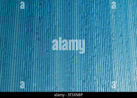 Close up detail of a blue ribbed plastic panel with vertical line pattern texture background. High Quality Photo Stock Photo