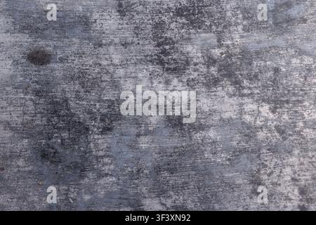 Flat lay texture of dark gray weathered concrete surface with fine scratches and mottled aged floor details. High Quality Photo Stock Photo
