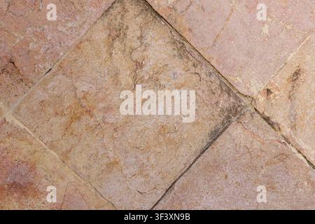 Close up top view of rustic vintage terracotta stone tiles placed diagonally on floor surface with natural weathered texture. High Quality Photo Stock Photo