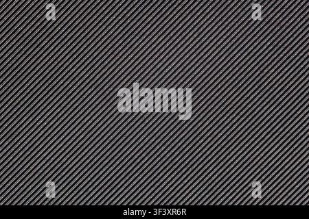 Close-up shot features dark fabric with fine, diagonal silver threads. The ribbed texture and metallic sheen create an elegant and modern appearance. Stock Photo