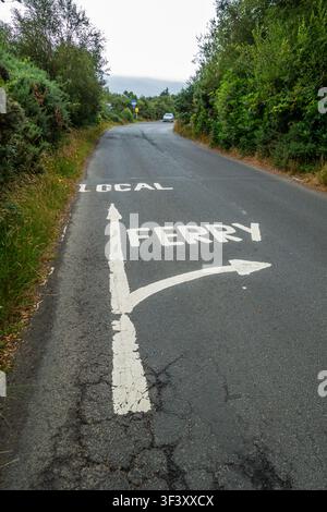 Road painted sign showing local route and route to the ferry, Scotland Stock Photo