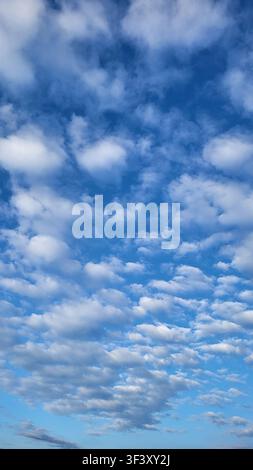 Altocumulus Cloud Formation Against a Deep Blue Sky in Switzerland Stock Photo
