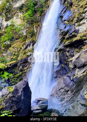 Majestic Waterfall Surrounded by Lush Green Vegetation in Valle Maggia Ticino Switzerland Stock Photo