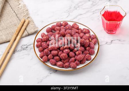 Purple coated crispy peanuts served in small plate Stock Photo