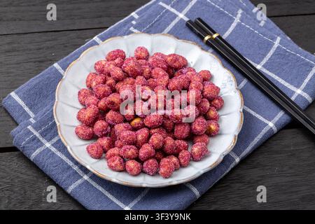 Purple coated crispy peanuts served in small plate Stock Photo
