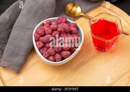 Purple coated crispy peanuts served in small plate Stock Photo