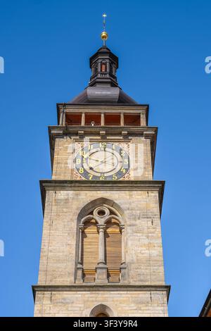 A tall Renaissance tower stands in Hradec Kralove. It features a large clock on the front. The clear blue sky surrounds the tower, making it a bright sight for visitors exploring the area. Stock Photo