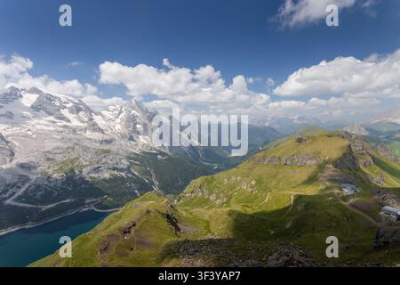 Dolomites mountains landscape with snow capped peaks and green valleys under blue sky Stock Photo