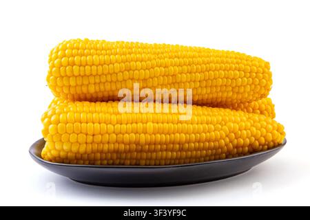 Boiled yellow waxy sweet corn cobs stack isolated on white background Stock Photo