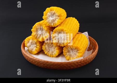 Boiled yellow waxy sweet corn cobs stack isolated on white background Stock Photo
