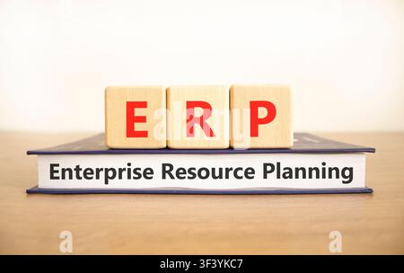 ERP enterprise resource planning symbol. Concept words ERP enterprise resource planning on beautiful wooden blocks and book. Beautiful white backgroun Stock Photo