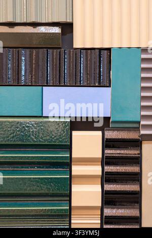 Assorted exterior facade material swatches in glossy and matte finishes, turquoise beige and black colors, showroom close-up Stock Photo