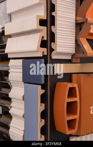Architectural facade panel samples with interlocking edges, colorful cladding materials, close-up construction industry display Stock Photo