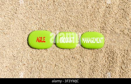 Agile product management words symbol. Concept words Agile product management on beautiful green stones. Beautiful sand background. Business agile pro Stock Photo