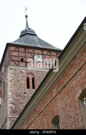 Groß Schönebeck, Germany - July 26, 2026: Immanuelkirche church tower showing fieldstone masonry, half-timbered belfry, and copper-clad bell dome. Stock Photo
