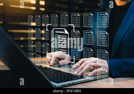 Document checklist management and compliance workflow concept. person using laptop, showing verified files, approval document, task validation, audit Stock Photo