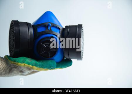 Close-up of a protective mask with two filters on the sides on a white background lies in the palm Stock Photo