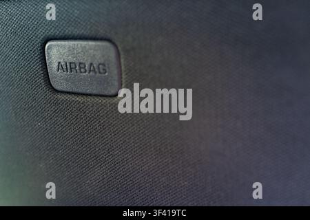 Close textured denim fills frame with stitched patch detail and woven thread pattern, showing blue textile surface with subtle highlights, soft shadow, clean minimal background, casual fashion feel Stock Photo