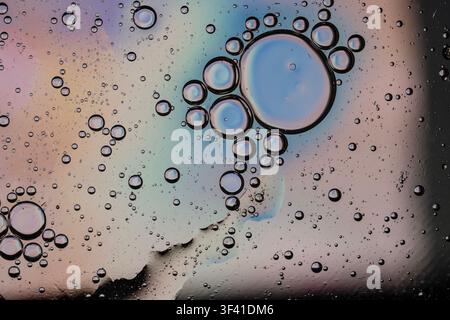 Oil bubbles and multicolored surface creating an abstract liquid texture Stock Photo